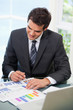 Man sitting on a chair while looking at graph Man sitting on a chair while looking at graph