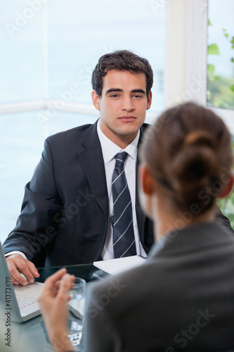 Photo: Businessman looking at his client Businessman looking at his client