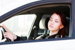 Girl looking in rear view mirror