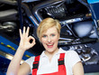 Female apprentice is happy and shows ok in a garage