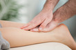 Physiotherapist massaging the calf of a woman