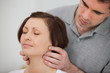 Physiotherapist massaging the neck of a patient