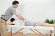 Woman lying while being massaged with a towel