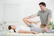 Photo: Woman lying on her back while being stretched Woman lying on her back while being stretched
