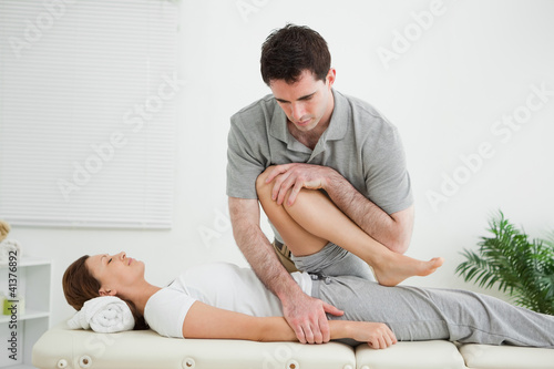 Photo: Brown-haired woman being stretched by a man Brown-haired woman being stretched by a man