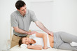 Serious practitioner massaging a peaceful woman Serious practitioner massaging a peaceful woman