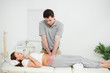 Peaceful woman being touched by an osteopath Peaceful woman being touched by an osteopath