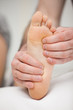 Fingertips touching the sole of a foot