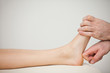 Physiotherapist using his forefinger to massage a foot
