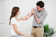 Serious practitioner touching the elbow of a woman