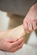 Barefoot being stretched by a doctor
