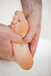 Thumbs of a doctor massaging a foot