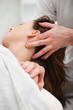 Close-up of chiropractor manipulating the neck of his patient