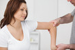 Doctor examining the arm of his patient