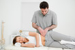 Peaceful woman being massaged on her hip by a doctor Peaceful woman being massaged on her hip by a doctor