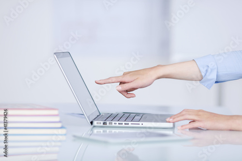 Foto: frau zeigt auf laptop-monitor frau zeigt auf laptop-monitor