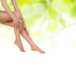 legs over green being massaged with hands legs over green being massaged with hands