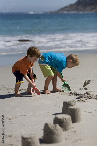 Photo: Boys making sand castles on the beach, Cape Town, South Africa Boys making sand castles on the beach, Cape Town, South Africa