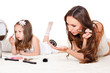 Foto: Mother and daughter with cosmetics Mother and daughter with cosmetics