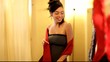 Mixed race woman trying on clothes in boutique