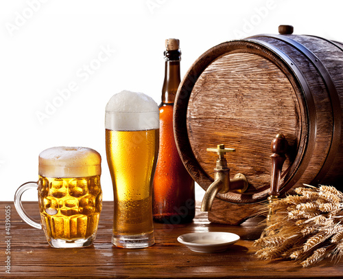 Photo: Beer barrel with beer glasses on a wooden table. Beer barrel with beer glasses on a wooden table.