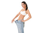 Pretty woman shows her weight loss by wearing an old jeans