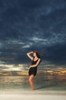 Fashion woman on the sea sunset background