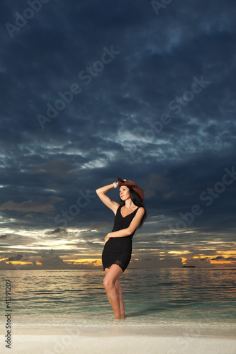 Photo: Fashion woman on the sea sunset background Fashion woman on the sea sunset background