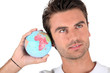 Man listening into a globe Man listening into a globe