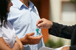 happy couple taking the keys for their new apartment