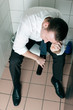 Young sleeping drunk man on the toilette