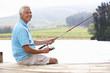Senior man fishing on jetty