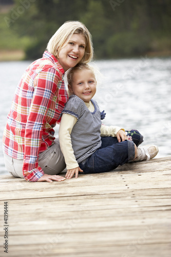 Photo: Mother and daughter sitting on a jetty Mother and daughter sitting on a jetty