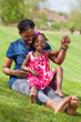 Adorable african mother with her daughter in the garden