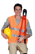 Worker in a reflective vest with helmet and boltcutters