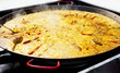 Paella rice from Valencia Spain cooking in big pan