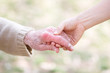 Senior and Young Women Holding Hands
