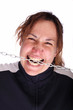 Young woman with open mouth biting a chain Young woman with open mouth biting a chain