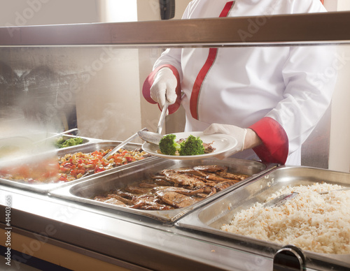 Photo: chef standing behind full lunch service station chef standing behind full lunch service station