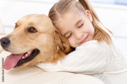 Photo: Cute little girl and dog embracing Cute little girl and dog embracing