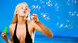 Photo: Young woman blowing bubbles on beach Young woman blowing bubbles on beach