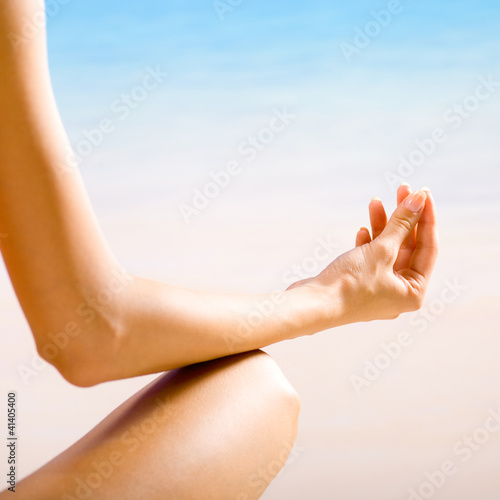 Photo: Woman doing yoga exercises or meditating Woman doing yoga exercises or meditating
