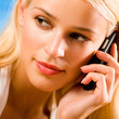 Young woman with cellphone on beach
