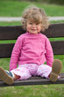 girl is sitteing on a park bench girl is sitteing on a park bench