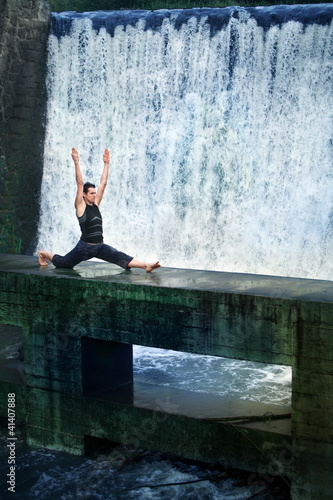 Photo: man doing the splits on footbridge at the waterfall man doing the splits on footbridge at the waterfall