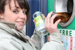 Woman recycling glass bottles