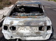 Photo: Burned out car in street Burned out car in street