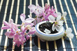 Jar of tea leaves and cherry blossoms with lilac