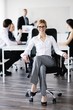 business woman with her staff in background