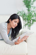 Woman reading a magazine while relaxing on a couch